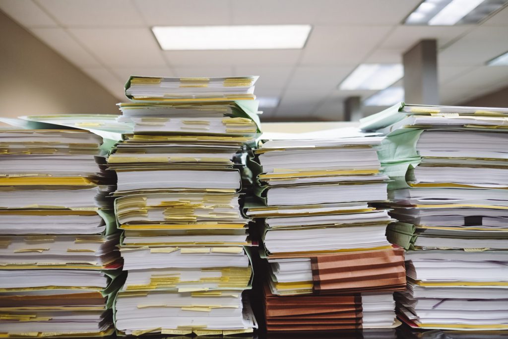 Four columns of paper documents, filing