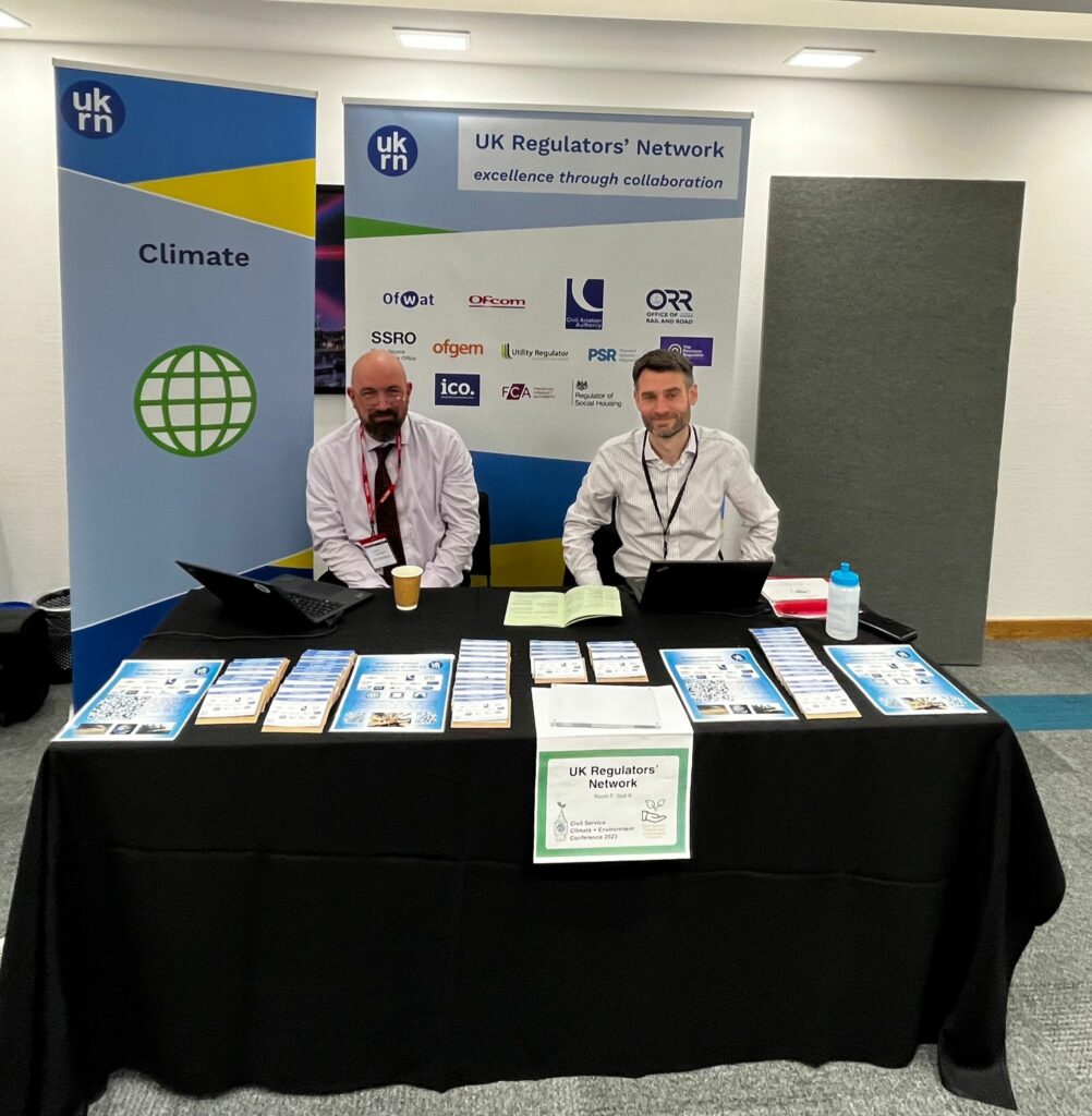 Mark Austin and Stephen Bass sitting at UKRN event stall.